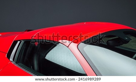 Windshield and roof of a red car