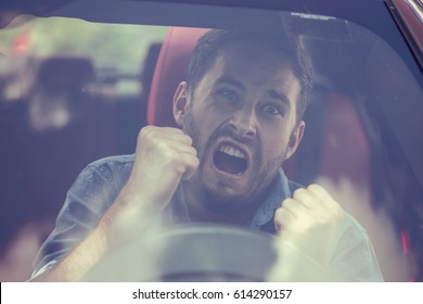 Windshield view of an angry driver man. Negative human emotions face expression 