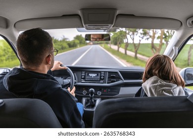 Windshield view. Driver in motion. Spring forest road
