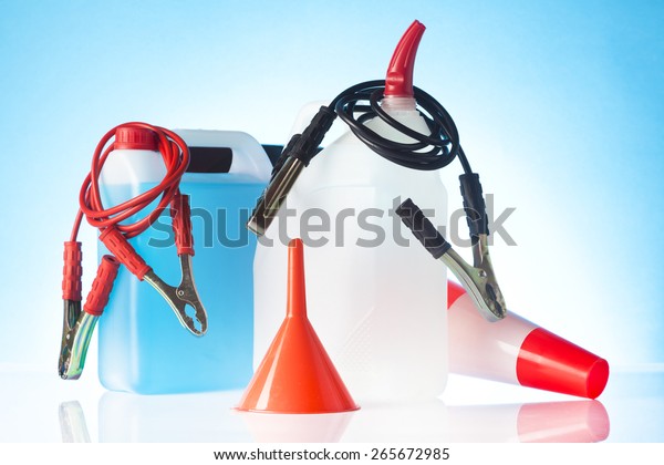 windshield\
washer fluids, funnel and jump start\
cable