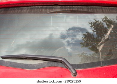 windshield wiper on dirty back glass of car