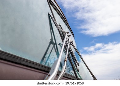 Windshield Wipers On Old Bus Exterior Against Blue Sky With Clouds