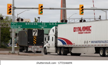 Windsor, Canada - May 21, 2020: Transport Trucks Pass Under A 