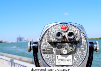 Windsor, ON - September 2019: Coin operated long range binoculars across from Detroit, Michigan. Blurry view of downtown Detroit, including the Renaissance Center