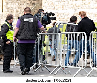 Windsor, UK, April, 2021 - WIndsor Castle Community Warden Coordinating The Barrier Layout And The Press Cameraman Leading Up To The Funeral Of Prince Philip, Duke Of Edinburgh