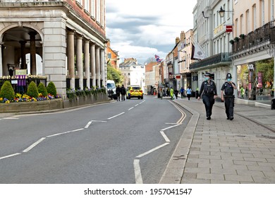 Windsor, UK, April, 2021 - Empty Windsor High Street With Two Police Officer Walking On The Pavement Opposite Side Of The Windsor Guildhall.