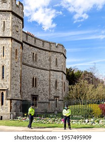 Windsor, UK, April, 2021 - Two Police Officers Stand Guard In Front Of The Entrance To Windsor Castle Where The Flowers Have Been Laid For The Funeral Of Prince Philip, Duke Of Edinburgh.