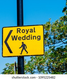 WINDSOR, UNITED KINGDOM - MAY 19, 2018: Royal Wedding yellow street sign with arrow for pedestrians to follow to marriage of Prince Harry, Duke of Sussex and the Duchess of Sussex Meghan Markle