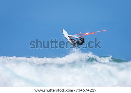 Windsurfer jumping in the waves