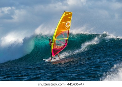 Windsurfer rides among the huge tubes and waves of the Indian Ocean on the island of Mauritius