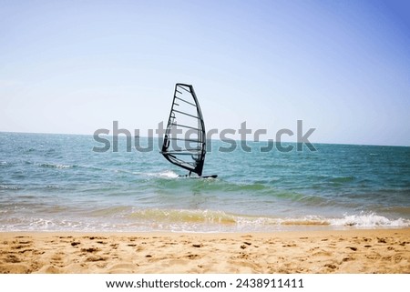Windsurfers enjoy riding the waves during the sunny summer months.