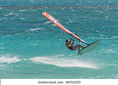 Windsurfing champion playing in the waves