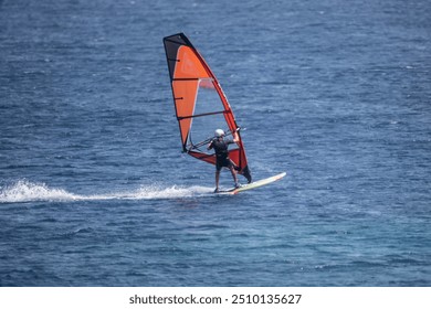 Windsurfing - like colorful butterflies against the blue sea in the bay on the island of Crete in Greece - Powered by Shutterstock