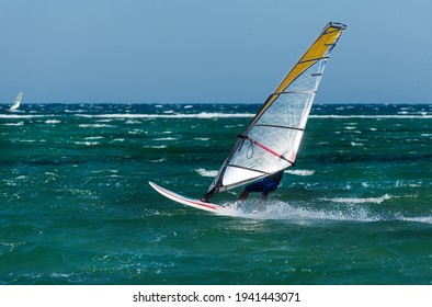 Windsurfing in the meltemi wind in Laguna beach south of the port of Naxos on the northwest coast of the Greek island of the same name in the Cyclades archipelago