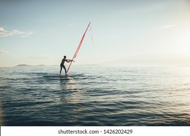 Windsurfing. Surfer Catching The Wind On The Wind Surfer Board