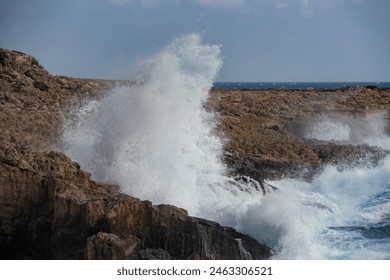 Windy sea waves crashing with power on the rocky coastline. Nature power wind stormy day. - Powered by Shutterstock