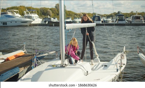 In Windy Weather In The Marina, The Women's Sailing Team Prepares The Yacht To Participate In The River Regatta.