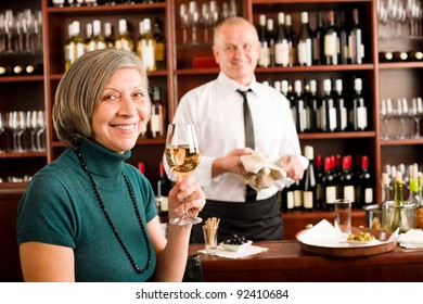 Wine Bar Senior Woman Enjoy Wine Glass In Front Of Bartender