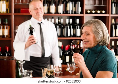 Wine Bar Senior Woman Enjoy Wine Glass In Front Of Bartender