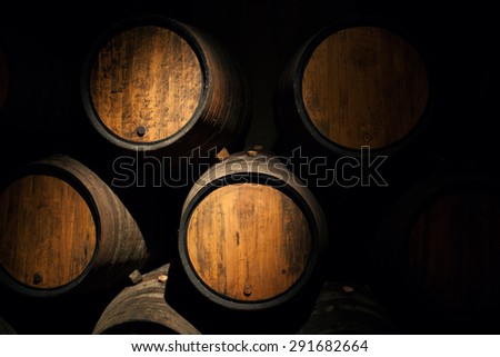 Wine barrels in a old wine cellar Wooden oak wine barrel