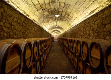 wine barrels stacked in a cave