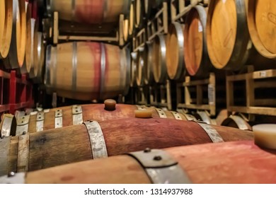 Wine Barrels Stacked In An Old Cellar At A Winery In Sonoma, USA