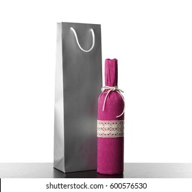 Wine Bottle And Gift Bag On White Background