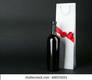 Wine Bottle And Gift Bag On Dark Background