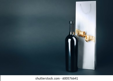 Wine Bottle And Gift Bag On Dark Background