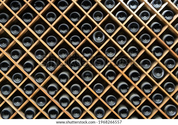Wine bottles background. Bottles of red\
and white wine in a wine cabinet of a liquor\
store