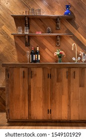 Wine Bottles And Flowers On A Home Wet Bar Counter