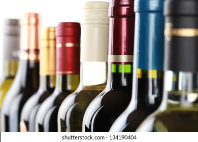 Wine bottles in a row isolated on a white background - Shutterstock ID 134190404