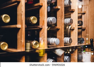 Wine Bottles Stacked On Wooden Racks