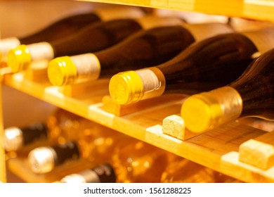 Wine bottles storage on wine rack in restaurant close up