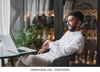 Wine Business Owner Looking At His Laptop Screen In The Tasting Room.