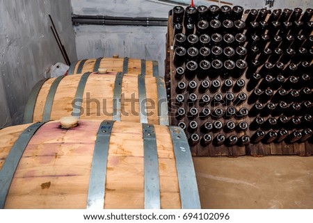 Wine casks and bottles in cellar