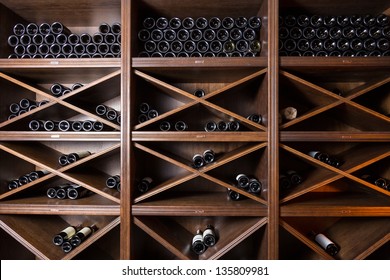 Wine cellar with bottles on wooden shelves
