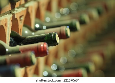 Wine cellar bottles rows covered with dust macro