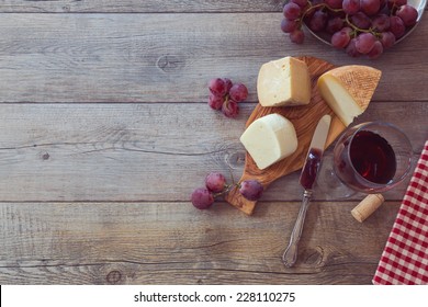 Wine, Cheese And Grapes On Wooden Table. View From Above With Copy Space