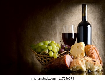 Wine, cheese, grapes and sausage on an old canvas - Powered by Shutterstock