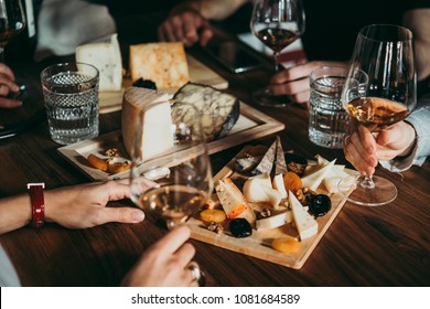 Wine and cheese served for a friendly party in a bar or a restaurant. - Shutterstock ID 1081684589