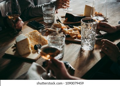 Wine and cheese served for a friendly party in a bar or a restaurant. - Shutterstock ID 1090079459
