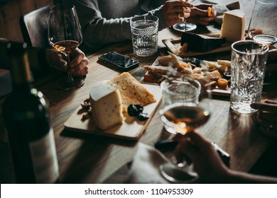 Wine and cheese served for a friendly party in a bar or a restaurant. - Shutterstock ID 1104953309