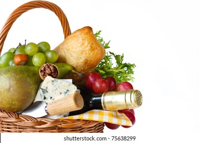 Wine, Ciabatta, Cheese, Herbs, Grapes And Pear In A Wicker Basket For Picnic.