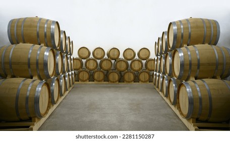 Wine or cognac barrels in the cellar of the winery, Wooden wine barrels in perspective. wine vaults. vintage oak barrels of craft beer or brandy. - Shutterstock ID 2281150287