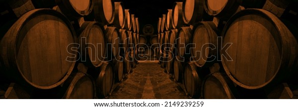 Wine or cognac barrels in the cellar of the\
winery, Wooden wine barrels in perspective. wine vaults. vintage\
oak barrels of craft beer or brandy.\
