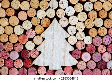 Wine corks with Christmas fir tree wooden toy as copy space, natural texture used bottle stoppers top view. Christmas background with close up wooden corks. New Year holidays wine concept - Powered by Shutterstock