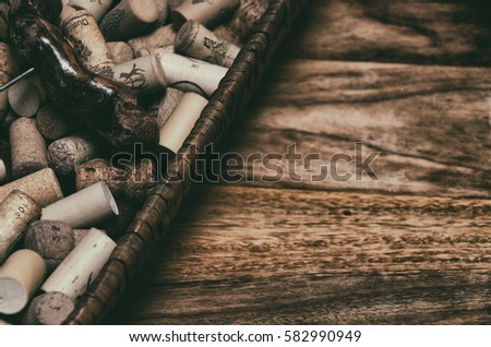 wine corks in a old basket bread on rosewood timber with copy space