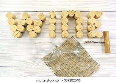 Wine corks on the table background and a wine glass