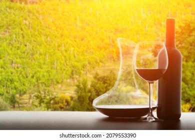 wine decanter, bottle of wine and glass, decantation oxygenation of the drink against the backdrop of vineyards and countryside in summer